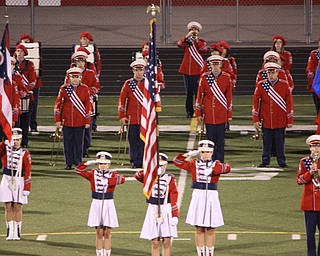 taps played by Fitch trumpet player in background of color guard with American flag during moment of silence for 9/11 at Friday nights game
