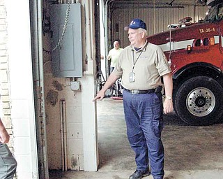 Boardman Fire Chief George Brown, shown here pointing to a water mark in a Windham, N.Y., fire station, returned to Boardman on Friday. He was helping emergency efforts in response to Hurricane and Tropical Storm Irene in Suffolk and Green counties.