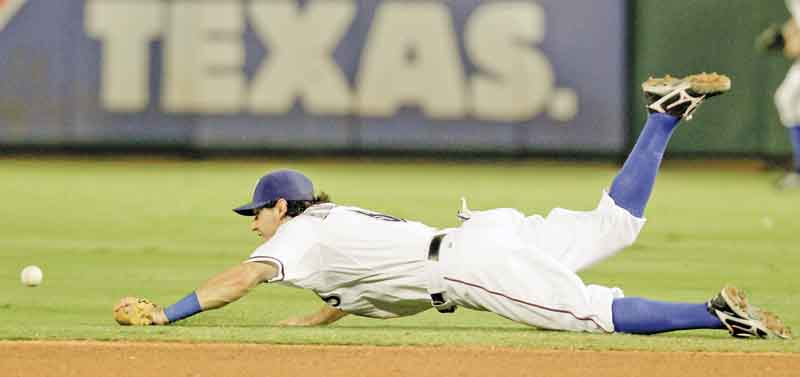 Texas Rangers second baseman Ian Kinsler is unable to reach a single by Cleveland Indians' Grady Sizemore in the fourth inning of a baseball game Tuesday, Sept. 13, 2011, in Arlington, Texas. (AP Photo/Tony Gutierrez)