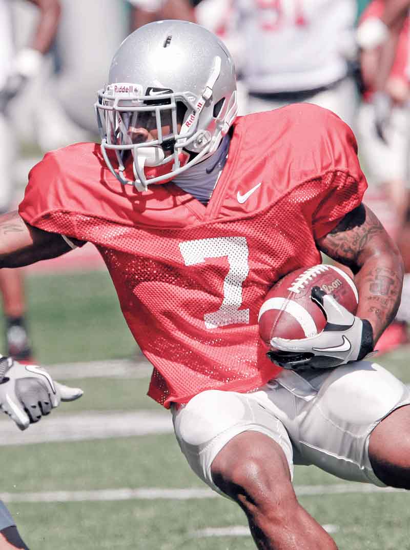 FILe - This Aug. 16, 2011, file photo, shows Ohio State running back Jordan Hall (7) looking for running room during an NCAA college football practice  in Columbus, Ohio. Records released by Ohio State Thursday night, Sept. 8, 2011, say three football players suspended for the opening game against Akron violated NCAA rules by taking $200 at a Cleveland charity event earlier this year. The players, running back Jordan Hall, defensive back Corey Brown and defensive back Travis Howard, were identified as having improperly received the money during a joint Ohio State-NCAA investigation on Aug. 31, 2011. (AP Photo/Terry Gilliam, File)