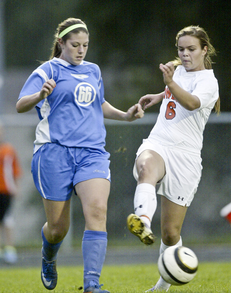 William D. Lewis  The Vindicator  Howland's Jenn Boyd kicks the ball past Maura Bobby of Poland during 9-14-11 game at Howland.