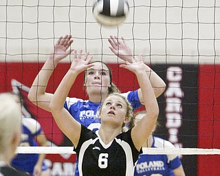 William D Lewis The Vindicator  Canfield's Ellie Rafoth #6 hits the ball while Poland's Aleah Hughes defends during Thursday action at Canfield.