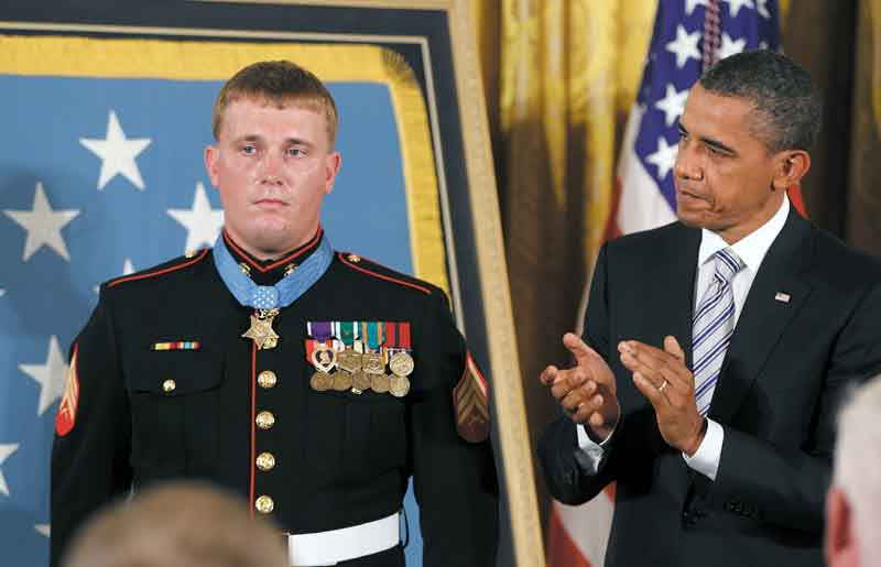 President Barack Obama applauds former Marine Cpl. Dakota Meyer, 23, of Greensburg, Ky., on Thursday after awarding him the Medal of Honor during a ceremony in the East Room of the White House in Washington.