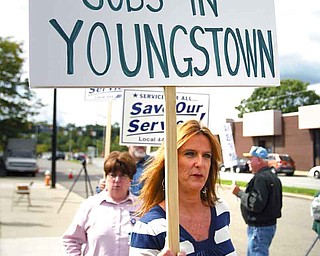 Patty Herlinger of Boardman walks among 75 others in front of the U.S. Post Office in downtown Youngstown. That processing and distribution plant employs 500 people and is on a U.S. Postal Service list of possible closures. The rally to draw attention to the possible closing was Friday.