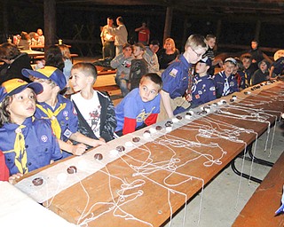 Members of Canfield Cub Scout Pack 25 and prospective Scouts competed in a doughnut-eating contest at last year’s Roundup at Brown Pavilion at Camp Stambaugh. The Roundup takes place each year in September to enable interested boys to experience Scouting. This year’s event will be Sept. 26.