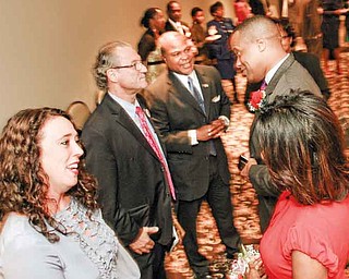 Michelle Hagan, left, and her husband, state Rep. Bob Hagan of Youngstown, D-60th district, greet Jay Williams and his wife, Sonja, before a dinner at Mr. Anthony’s in Boardman. The Youngstown Warren Black Caucus hosted the dinner to honor Williams.