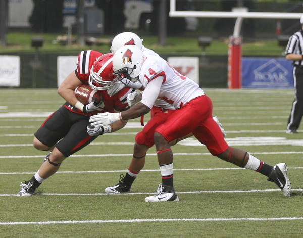 JESSICA M. KANALAS | THE VINDICATOR..Youngstown's tight end Carson Sharbaugh, number 86, is tackled by Illinois State's linebacker Josh Howe and safety Matt Goldsmit during the first quarter...-30
