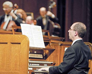 American organist David Higgs plays Stambaugh Auditorium’s restored organ during a rededication concert Sunday. Higgs was the guest organist and played alongside the Youngstown Symphony Orchestra.