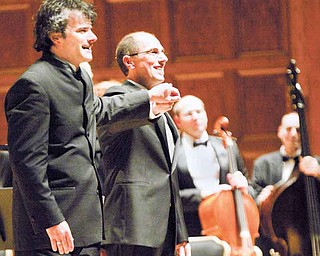 Randall Craig Fleischer, left, conductor for the Youngstown Symphony Orchestra, and David Higgs, organist from the Eastman School of Music in Rochester, N.Y., turn toward hundreds of people in the crowd at Stambaugh Auditorium on Sunday. The concert also celebrated the 80th anniversary of the Youngstown Symphony Orchestra.