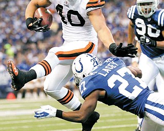 Cleveland Browns running back Peyton Hillis leaps over Indianapolis Colts cornerback Jacob Lacey in the second quarter of an NFL football game in Indianapolis, Sunday, Sept. 18, 2011. (AP Photo/AJ Mast)
