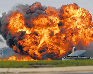 A single engine T-28 from the six-plane Trojan Horsemen Demonstration Flight Team crashes and explodes during a performance at the Thunder Over the Blue Ridge Open House and Air Show, Saturday, Sept. 17, 2011 at the 167th Airlift Wing in Martinsburg, W.Va. (AP Photo/Journal Newspaper, Ron Agnir)