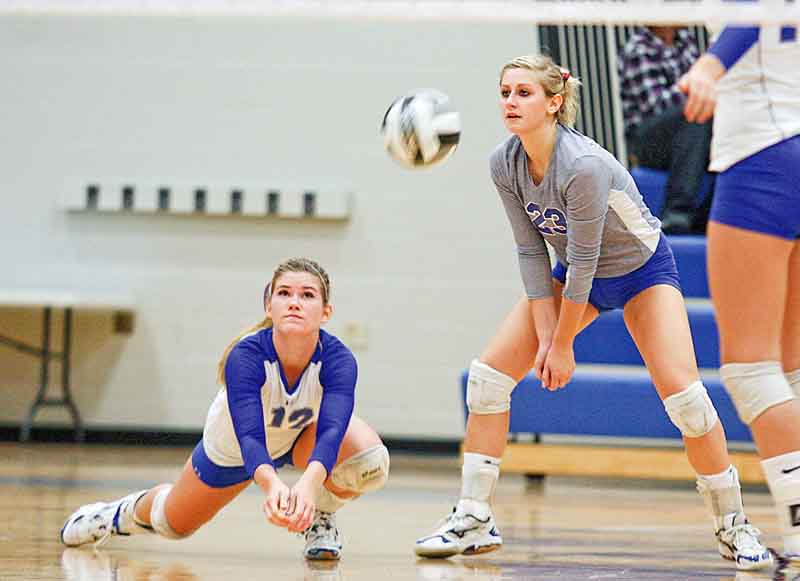Emily Perry (23) and Kaitlyn Evans (12) of Hubbard make a play on the ball Monday evening in Hubbard. The Eagles won the third set, 30-28, but fell in the fourth.