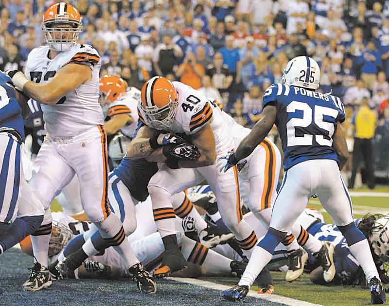 Cleveland Browns running back Peyton Hillis, center, scores in front of Indianapolis Colts cornerback Jerraud Powers (25) in the second quarter of an NFL football game in Indianapolis, Sunday, Sept. 18, 2011. (AP Photo/Darron Cummings)