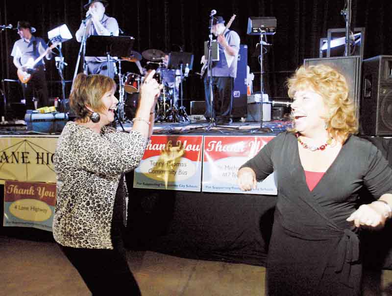 Beverly Schumann, left, executive director of teaching and learning at Youngstown city schools, and Kimberly Rose, a teacher at Kirkmere Elementary School, let loose on the dance floor during the Celebrate Forward event Tuesday at the Covelli Centre. 