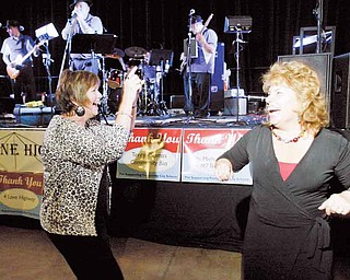 Beverly Schumann, left, executive director of teaching and learning at Youngstown city schools, and Kimberly Rose, a teacher at Kirkmere Elementary School, let loose on the dance floor during the Celebrate Forward event Tuesday at the Covelli Centre.