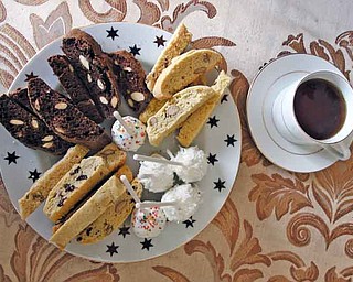 A cup of coffee is pictured with an assortment of Sweet D Bites’ biscottis. Fusillo started the online bakery after growing tired of the daily work grind and out of hopes of spending more time with her children.