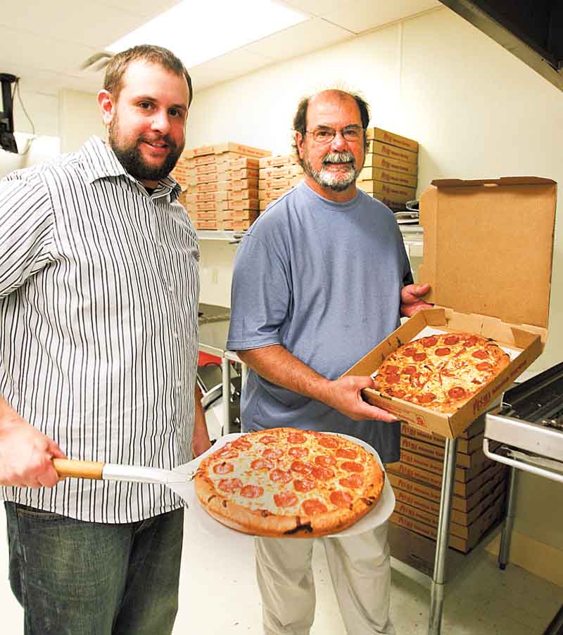 Dave Morgan, right, and his son, Josh, have run the Liberty Belleria Pizza, 5718 Belmont Ave., for about 18 months, but they haven’t seen the business they expected. The pizza shop is located about a mile north of the Liberty business district.