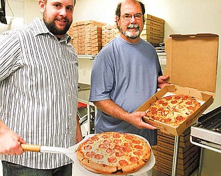 Dave Morgan, right, and his son, Josh, have run the Liberty Belleria Pizza, 5718 Belmont Ave., for about 18 months, but they haven’t seen the business they expected. The pizza shop is located about a mile north of the Liberty business district.