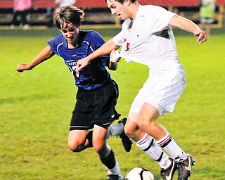 Cuyahoga Valley Christian Academy’s Zach Bosshard, left, grabs Cardinal Mooney soccer player Pat Price during Tuesday’s 1-1 tie in Struthers.