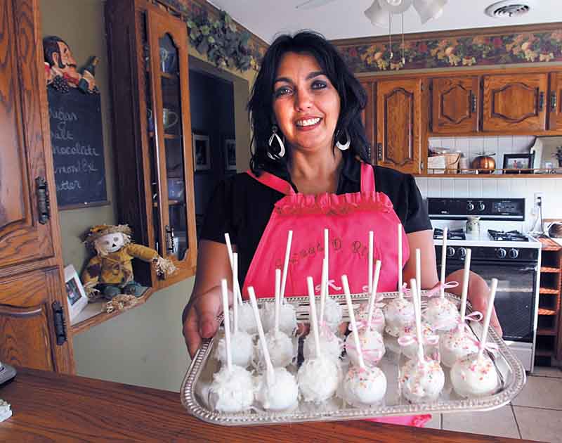 Deanna Fusillo shows off the Sweet D Bites, the signature cake/truffle item and the name of her online bakery. She delivers baked goods both locally and nationwide. 