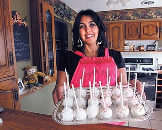 Deanna Fusillo shows off the Sweet D Bites, the signature cake/truffle item and the name of her online bakery. She delivers baked goods both locally and nationwide.