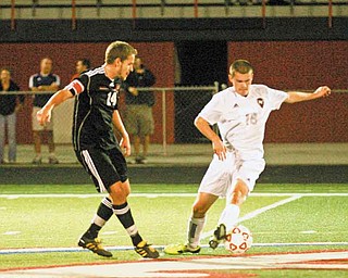 Austintown Fitch junior Kyle Kosco, 18, controls the ball against Canfield’s Mike Thomas, in the first half of Thursday’s AAC boys soccer game in Austintown.