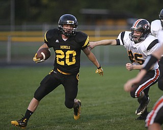 ROBERT  K.  YOSAY  | THE VINDICATOR --..Missed as Crestvies #20 Kris Simpson moves quickly oout of the outstretched arms of #25 Christian Feezle  as Kris scampered for  a  first quarter  First Down  as the Crestview Rebels hosted the Springfield Tigers at Crestview Stadium ..--30-..(AP Photo/The Vindicator, Robert K. Yosay)