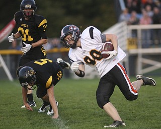 ROBERT  K.  YOSAY  | THE VINDICATOR --..Springfield Tigers #80 Jeremy Weingart  takes off as Crestviews #5 Dillon Gorby and #31 Tom Oliver look on - Jeremy was stopped after a few yards as the Crestview Rebels hosted the Springfield Tigers at Crestview Stadium ..--30-..(AP Photo/The Vindicator, Robert K. Yosay)
