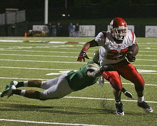 JESSICA M. KANALAS | THE VINDICATOR ..Ursuline's defensive back Anthony Davis, 1, tackles Steubenville's player during the second quarter of Friday night's game at YSU stadium.  ..-30
