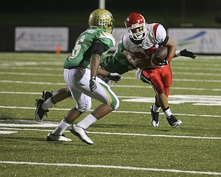 JESSICA M. KANALAS | THE VINDICATOR ..Ursuline's defensive back's Shannon Hightower, 6, and Deon Jackson, 30, tackle Steubenville's player during the second quarter of Friday night's game at YSU stadium. ..-30