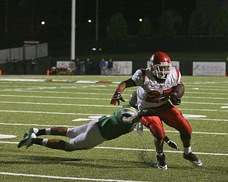 JESSICA M. KANALAS | THE VINDICATOR ..Ursuline's defensive back Anthony Davis, 1, tackles Steubenville's player during the second quarter of Friday night's game at YSU stadium. ..-30
