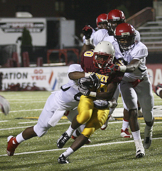 JESSICA M. KANALAS | THE VINDICATOR ..Mooney's junior running back Justus Ellis-Moore fights off the Red Lion Christian Academy's defense during the first quarter of Saturday night's game at YSU stadium. ..-30