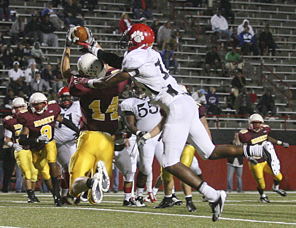 JESSICA M. KANALAS | THE VINDICATOR ..Mooney's senior wide receiver Ryan Farragher intercepts the ball from a pass intended for junior wide receiver Neiko Creamer of the Red Lion Christian Academy during the second quarter of Saturday night's game at YSU stadium. ..-30