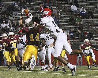 JESSICA M. KANALAS | THE VINDICATOR ..Mooney's senior wide receiver Ryan Farragher intercepts the ball from a pass intended for junior wide receiver Neiko Creamer of the Red Lion Christian Academy during the second quarter of Saturday night's game at YSU stadium. ..-30