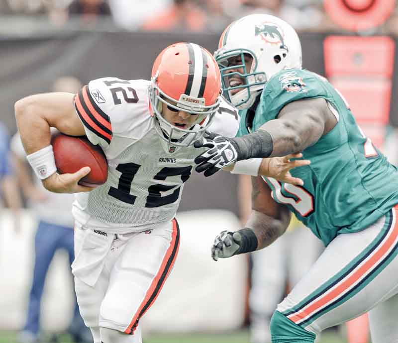 Miami Dolphins defensive end Kendall Langford, right, pressures Cleveland Browns quarterback Colt McCoy in the first quarter in an NFL football game on Sunday, Sept. 25, 2011, in Cleveland.  (AP Photo/Mark Duncan)