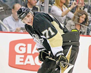 Pittsburgh Penguins' Evgeni Malkin (71), or Russia, lines up for a face off during the second period of an NHL pre-season hockey game against the Detroit Red Wings in Pittsburgh Wednesday, Sept. 21, 2011. (AP Photo/Gene J. Puskar)