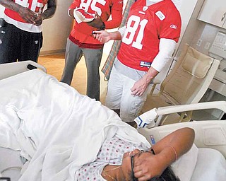 San Francisco 49ers players, from left, Delanie Walker, Vernon Davis and Justin Peelle visit patient Teasia Tarver, 15, of Youngstown at the Akron Children’s Hospital Mahoning Valley in Boardman. 