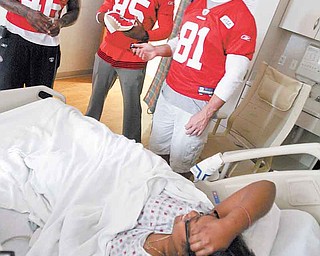 San Francisco 49ers players, from left, Delanie Walker, Vernon Davis and Justin Peelle visit patient Teasia Tarver, 15, of Youngstown at the Akron Children’s Hospital Mahoning Valley in Boardman.