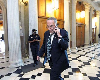 Sen. Charles Schumer, D-N.Y., a key member of the Senate Democratic leadership, walks on Capitol Hill in Washington, Monday, Sept. 26, 0211, as the Senate prepares to vote on a short-term funding measure that includes dollars for disaster relief without an offsetting spending cut elsewhere, as demanded by the GOP-controlled House. (AP Photo/J. Scott Applewhite)