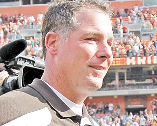 Cleveland Browns coach Pat Shurmur walks off the field with a game ball after the Browns beat the Miami Dolphins 17-16 in an NFL football game Sunday, Sept. 25, 2011, in Cleveland.  (AP Photo/Amy Sancetta)