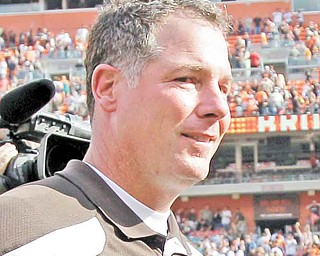 Cleveland Browns coach Pat Shurmur walks off the field with a game ball after the Browns beat the Miami Dolphins 17-16 in an NFL football game Sunday, Sept. 25, 2011, in Cleveland. (AP Photo/Amy Sancetta)