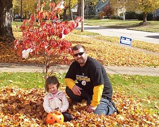 Is that practice for trick-or-treating? Mikayla Upright takes a break from stuffing her pumpkin with leaves with her Uncle Josh Upright. Both are from Boardman. Photo sent in by Sheree Savon of Youngstown.