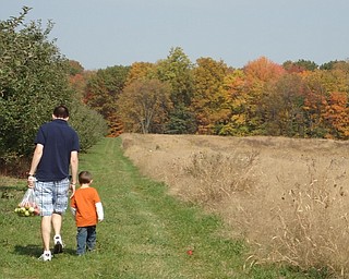 Tricia Dell of Austintown sent in this photo she took of her husband, Phillip, and their son Patrick as they walk in the apple orchards in Hartford, Ohio.