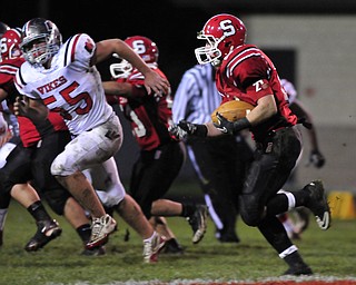Running back Nick Pollifrone #21 of Struthers looks for room around the edge on a running play.