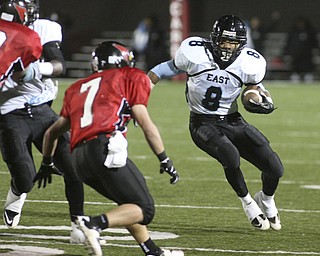 ROBERT K. YOSAY | THE VINDICATOR..East s #8 DD Fleetion makes a move for a first down on #7 Mike Ross - Canfield...East Panthers at Canfield Cardinals .....-30