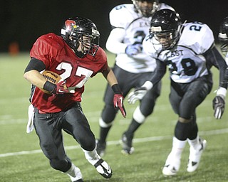 ROBERT K. YOSAY | THE VINDICATOR..Canfield #27 Ben Angelo makes the cut in front #28 East - Daveon Harris #25 Juwan Madison ..East Panthers at Canfield Cardinals .....-30