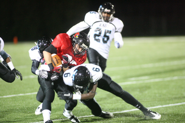 ROBERT K. YOSAY | THE VINDICATOR..#27   Ben Angelo   is stopped by #9 Antwain Stuart   behind him is #25  Juwann Madison ..East  Panthers at Canfield Cardinals .....-30