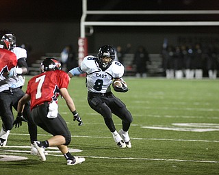 ROBERT K. YOSAY | THE VINDICATOR..East s #8 DD Fleetion makes a move for a first down on #7 Mike Ross - Canfield...East Panthers at Canfield Cardinals .....-30