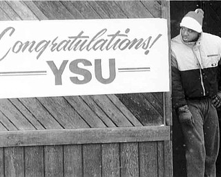 01/17/91 - Doug Oster.YSU player, Aaron Green waits on 5th Ave. for the parade to start. Green was waiting to get on the float with the rest of the players.