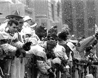 01/17/91 - Doug Oster.YSU Parade: YSU team on a flatbed as people cheer for them.